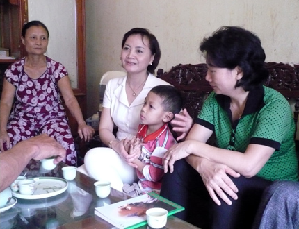Đồng chí Phạm Thị Thanh Trà - Bí thư Thành ủy Yên Bái (người ngồi giữa) thăm hỏi gia đình có trẻ em bị ảnh hưởng HIV/AIDS tại phường Yên Thịnh. (Ảnh: Thanh Nghị)